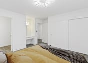 Thumbnail 5 of 8 - a bedroom with white closets and a large bed