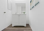 Thumbnail 8 of 8 - a white bathroom with a sink and a mirror