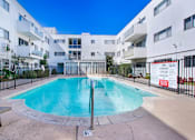Thumbnail 19 of 20 - a swimming pool in front of an apartment building