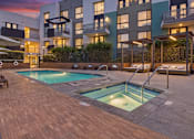 Thumbnail 26 of 40 - A modern building with a pool in the backyard.