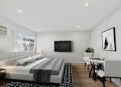 Thumbnail 27 of 79 - A modern bedroom with a large bed and a television on the wall.