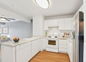 Thumbnail 13 of 40 - a kitchen with white cabinetry and a wooden floor