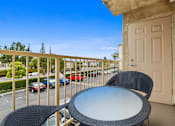 Thumbnail 22 of 40 - a balcony with a table and chairs and a door