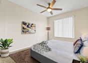 Thumbnail 20 of 40 - a bedroom with a large bed and a ceiling fan