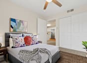 Thumbnail 21 of 40 - a bedroom with white walls and a ceiling fan