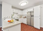 Thumbnail 3 of 40 - a kitchen with white cabinets and stainless steel appliances