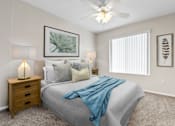 Thumbnail 9 of 40 - a bedroom with a large bed and a ceiling fan
