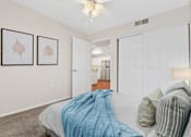 Thumbnail 10 of 40 - a bedroom with a bed and a ceiling fan