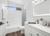 Thumbnail 9 of 40 - a bathroom with a sink and a shower and a toilet