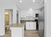 Thumbnail 96 of 135 - A modern kitchen with a granite countertop and stainless steel appliances.