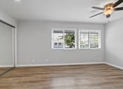 Thumbnail 101 of 135 - A room with a ceiling fan and a window with blinds.
