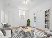 Thumbnail 2 of 32 - A living room with a patterned rug and a coffee table.