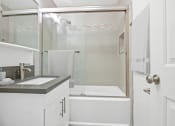 Thumbnail 30 of 135 - a white bathroom with a shower and a sink