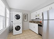 Thumbnail 3 of 24 - a washer and dryer in a kitchen with a sink and refrigerator