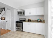 Thumbnail 2 of 24 - a kitchen with stainless steel appliances and white cabinets