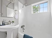 Thumbnail 10 of 24 - a bathroom with a sink and a tub and a window