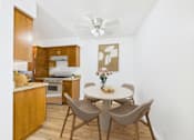 Thumbnail 11 of 19 - A kitchen with a table and chairs.