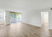 Thumbnail 15 of 19 - the living room and dining room of an empty house with wood floors and white walls