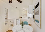 Thumbnail 1 of 11 - A kitchen with a marble table and a ceiling fan.