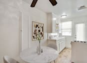 Thumbnail 6 of 11 - A white marble table with a vase on it in a kitchen.