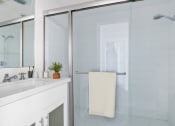 Thumbnail 7 of 86 - a white bathroom with a shower and a sink