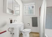 Thumbnail 11 of 35 - a bathroom with a sink and a toilet and a shower