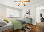 Thumbnail 4 of 35 - a bedroom with a bed and a ceiling fan