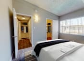 Thumbnail 13 of 23 - a bedroom with a bed and a door to a walk in closet
