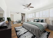 Thumbnail 39 of 41 - A bedroom with a large bed and a ceiling fan.