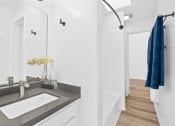Thumbnail 15 of 21 - a bathroom with a sink and a mirror