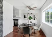 Thumbnail 2 of 8 - a dining room with a table and chairs and a ceiling fan