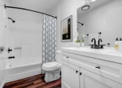 Thumbnail 5 of 8 - a bathroom with a toilet and a tub and a sink