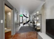 Thumbnail 18 of 45 - a living room with a tv and a staircase in the background