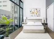Thumbnail 4 of 45 - Studio Apartments In Downtown Los Angeles, CA - Broadway Lofts - High Ceiling Bedroom With Sliding Door Closet And Floor to Ceiling Large Windows