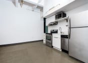 Thumbnail 22 of 45 - a kitchen with a refrigerator freezer and a stove top oven