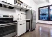 Thumbnail 25 of 45 - a kitchen with a stove top oven next to a refrigerator