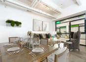 Thumbnail 3 of 45 - a dining area with a wooden table and chairs