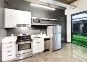 Thumbnail 27 of 45 - a kitchen with white cabinets and stainless steel appliances