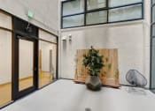 Thumbnail 30 of 45 - a room with a plant and a chair in front of a building