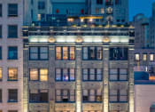 Thumbnail 35 of 45 - a large building with many windows and a street in front of it