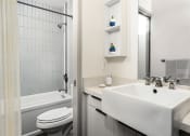 Thumbnail 5 of 45 - a bathroom with a sink toilet and bathtub