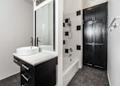 Thumbnail 10 of 37 - Lofts In Downtown Los Angeles, CA - Mercantile Lofts - Bathroom With Modern Features, Tiles, And Shower With Tub.