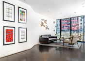 Thumbnail 11 of 37 - Apartments In Downtown Los Angeles For Rent - Mercantile Lofts - Living Room With Polished Concrete Flooring, Floor-to-Ceiling Windows with Beautiful Natural Light, And City Views