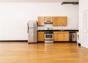 Thumbnail 14 of 37 - Downtown Los Angeles Apartments - Mercantile Lofts -Open Concept Kitchen With Bamboo Wood Flooring And Stainless Steel Kitchen Appliances