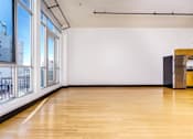 Thumbnail 35 of 37 - an empty room with wood floors and large windows