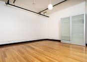 Thumbnail 37 of 37 - an empty room with white walls and a wooden floor