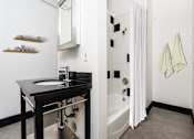 Thumbnail 15 of 37 - a bathroom with a sink and a bathtub