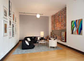 Thumbnail 18 of 37 - a living room with a black couch and a white chair