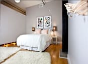 Thumbnail 27 of 37 - a bedroom with a bed and two paintings on the wall
