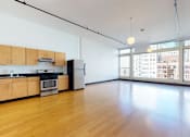 Thumbnail 32 of 37 - an empty room with a large window and wood floors